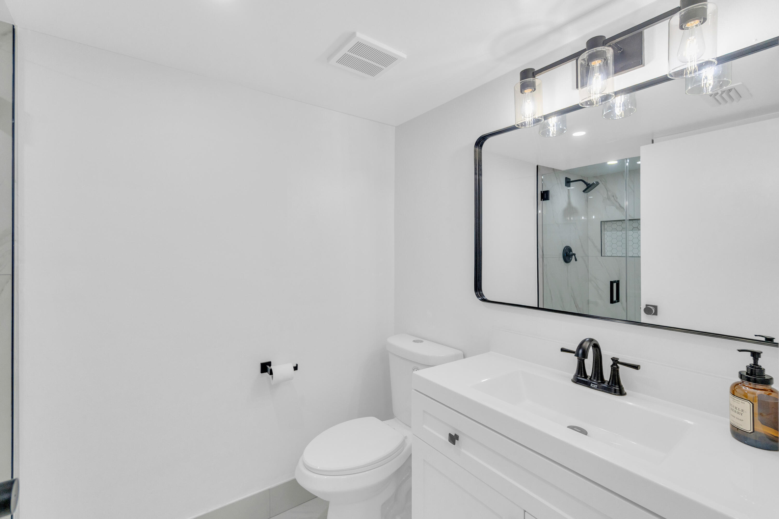 400 Crestwood Court North, Unit 420 Royal Palm Beach, FL 33411 - Photo 16 of 44 a bathroom with a sink a toilet and mirror