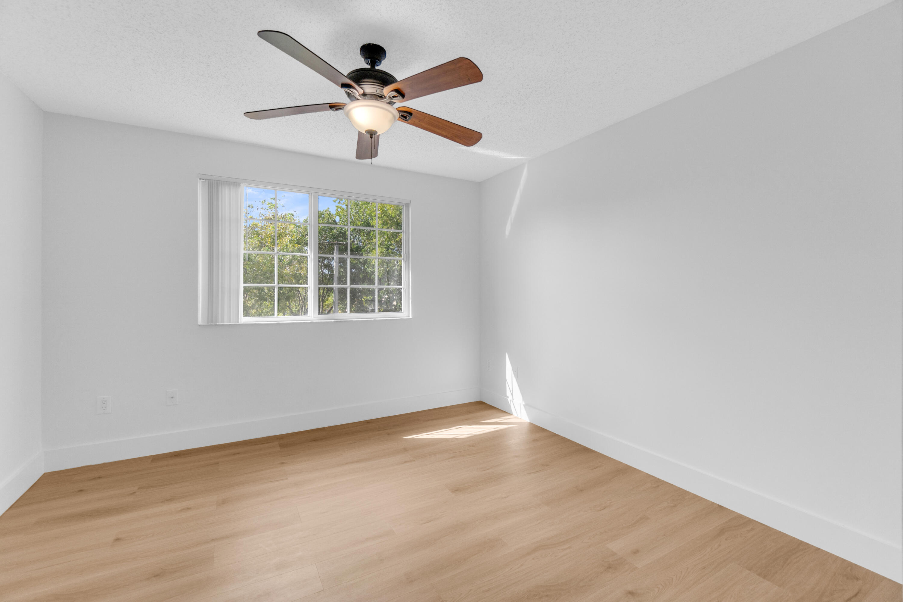 400 Crestwood Court North, Unit 420 Royal Palm Beach, FL 33411 - Photo 17 of 44 wooden floor in an empty room with a window