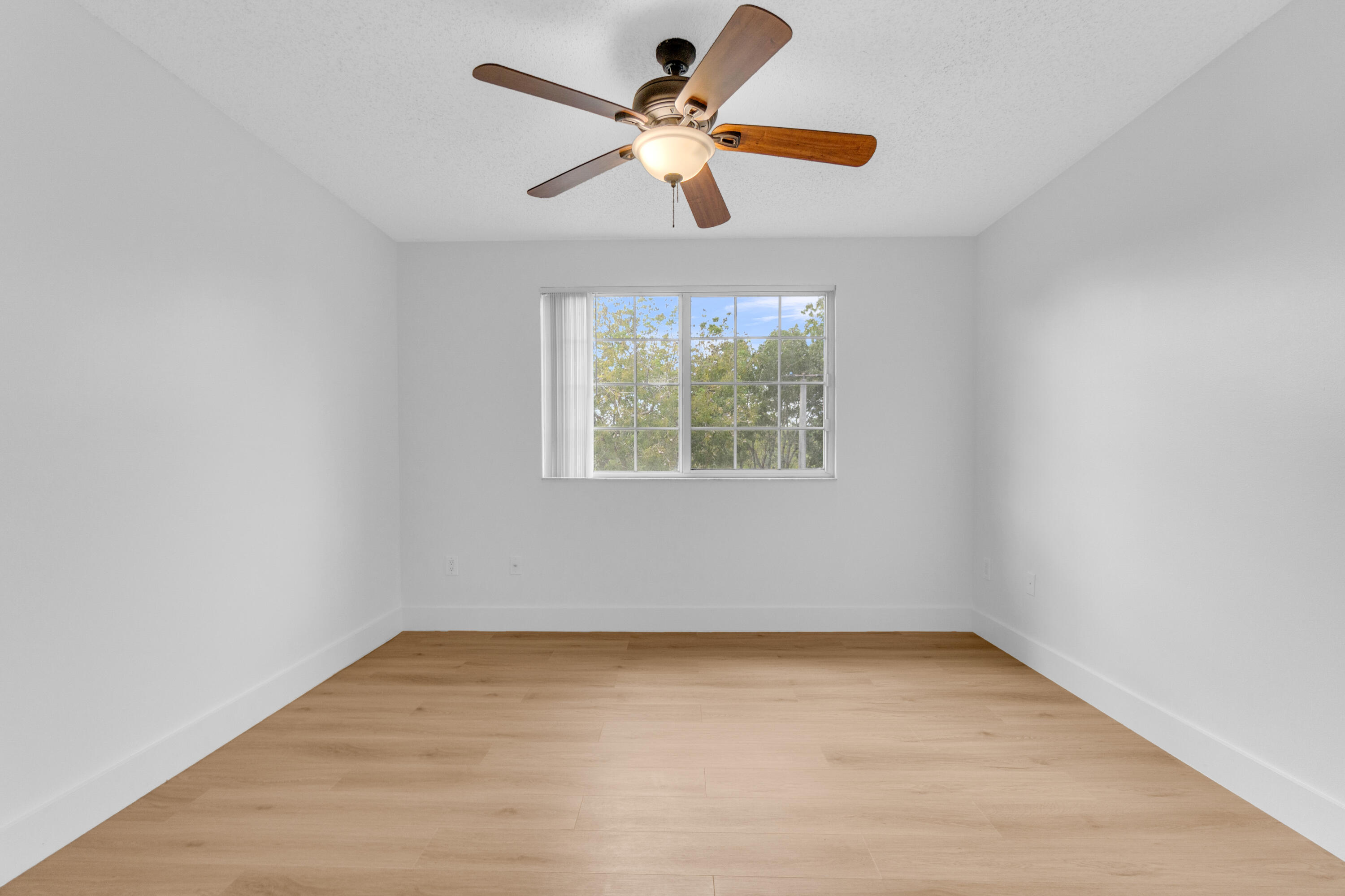 400 Crestwood Court North, Unit 420 Royal Palm Beach, FL 33411 - Photo 18 of 44 wooden floor in an empty room with a window