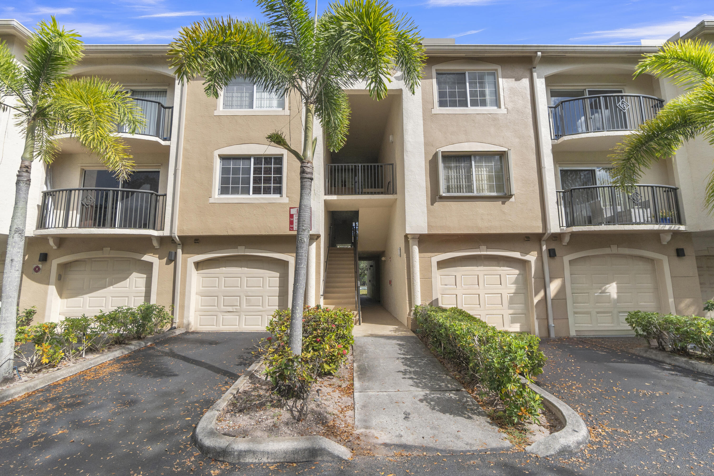 400 Crestwood Court North, Unit 420 Royal Palm Beach, FL 33411 - Photo 2 of 44 front view of a house with a yard