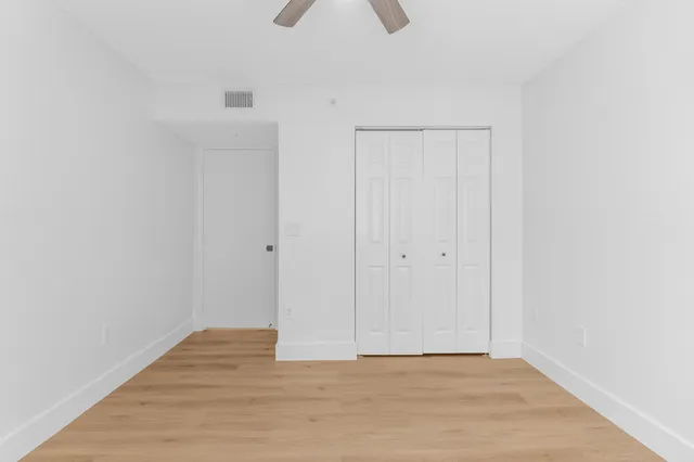 a view of an empty room and wooden floor