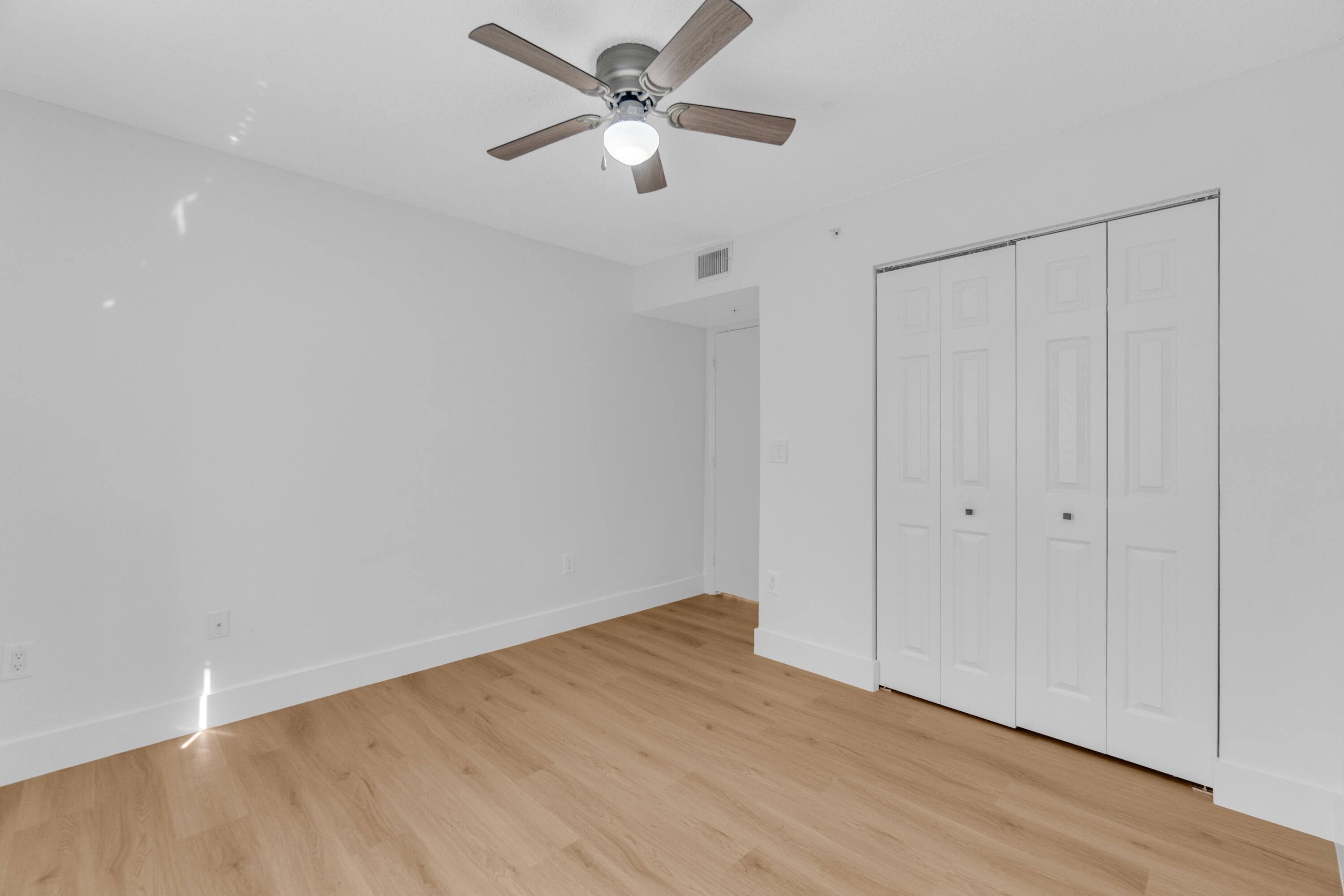 400 Crestwood Court North, Unit 420 Royal Palm Beach, FL 33411 - Photo 22 of 44 a view of a big room with wooden floor closet and ceiling fan