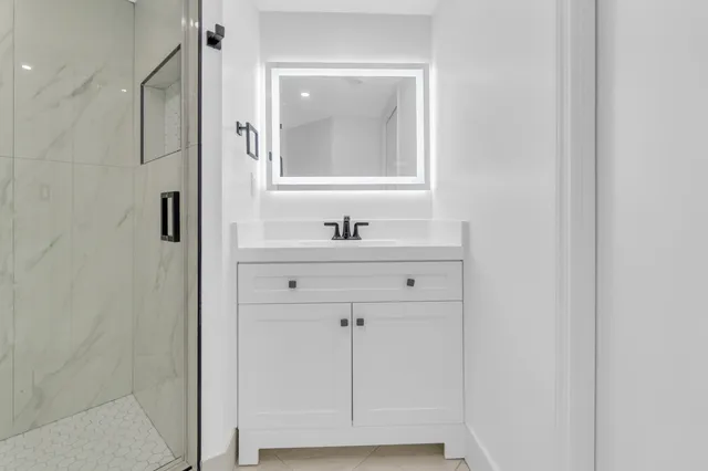 a view of a big room with wooden floor closet and windows
