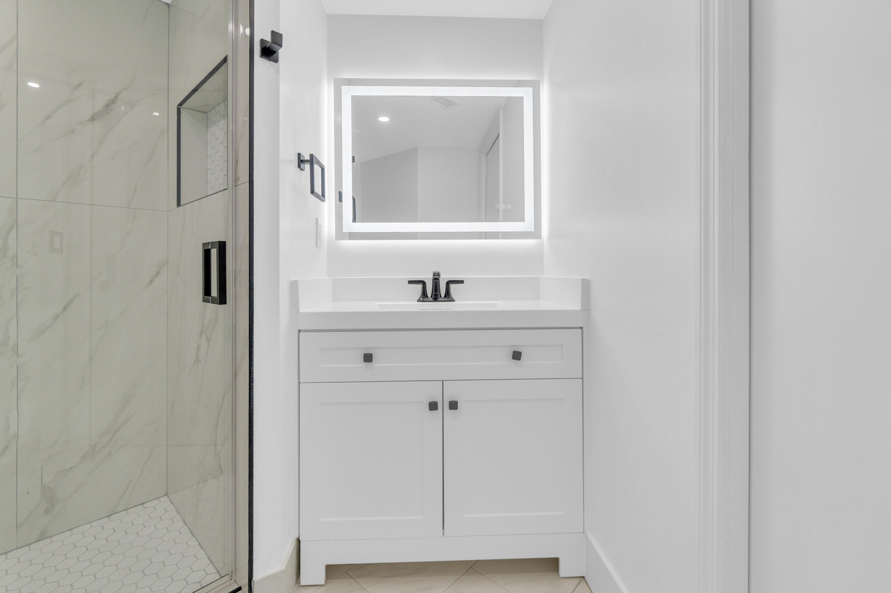 400 Crestwood Court North, Unit 420 Royal Palm Beach, FL 33411 - Photo 23 of 44 a bathroom with a sink and a mirror