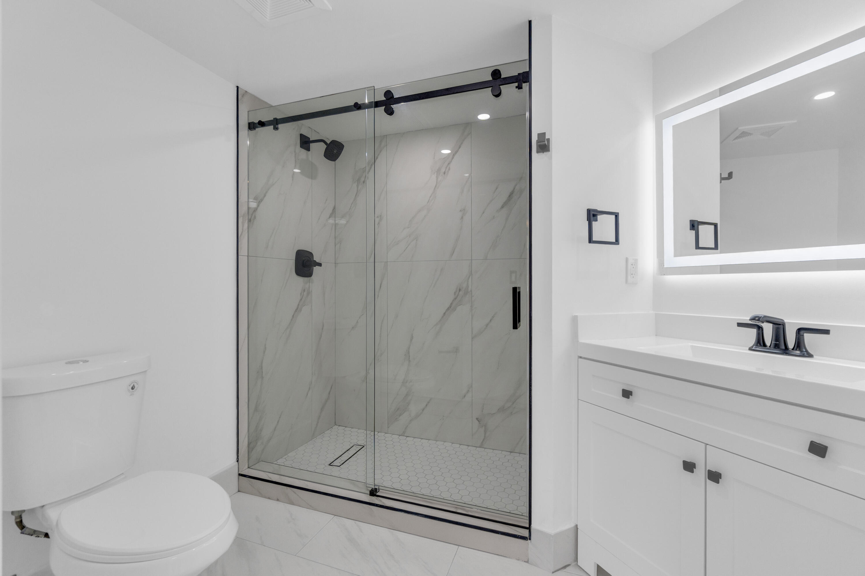 400 Crestwood Court North, Unit 420 Royal Palm Beach, FL 33411 - Photo 25 of 44 a bathroom with a shower a toilet and a sink