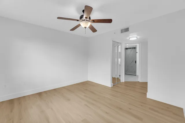 a kitchen with white cabinets stainless steel appliances and sink