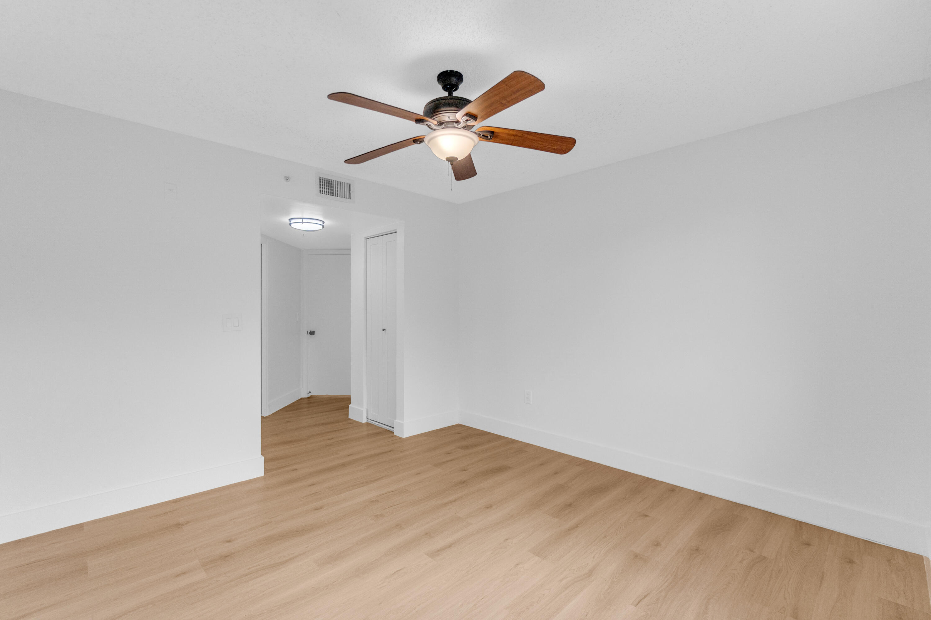 400 Crestwood Court North, Unit 420 Royal Palm Beach, FL 33411 - Photo 27 of 44 a view of empty room with wooden floor