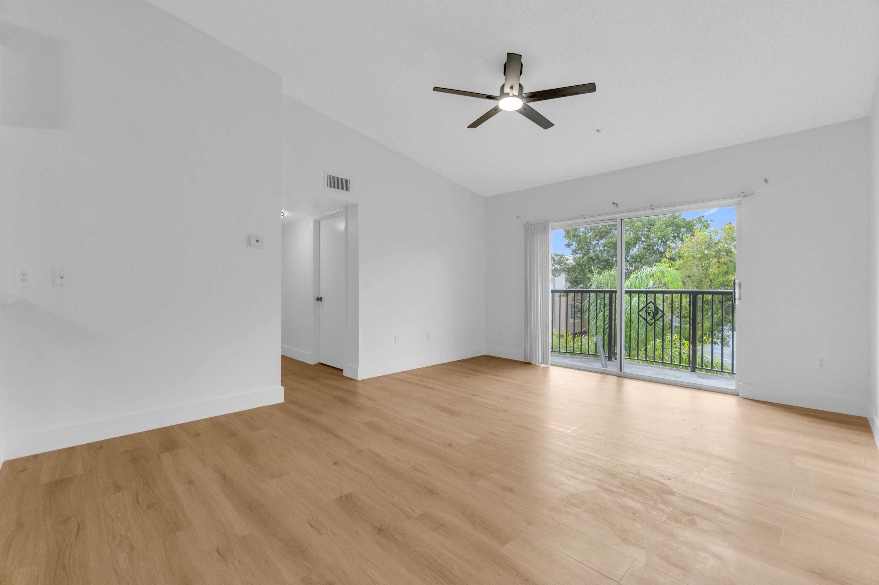 400 Crestwood Court North, Unit 420 Royal Palm Beach, FL 33411 - Photo 30 of 44 wooden floor in an empty room with a window