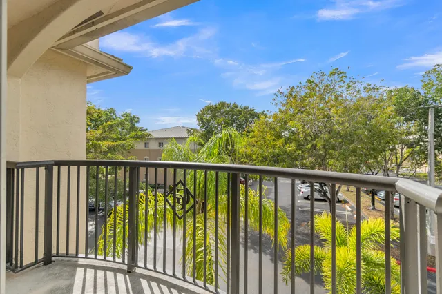 a kitchen with a refrigerator sink and white cabinets