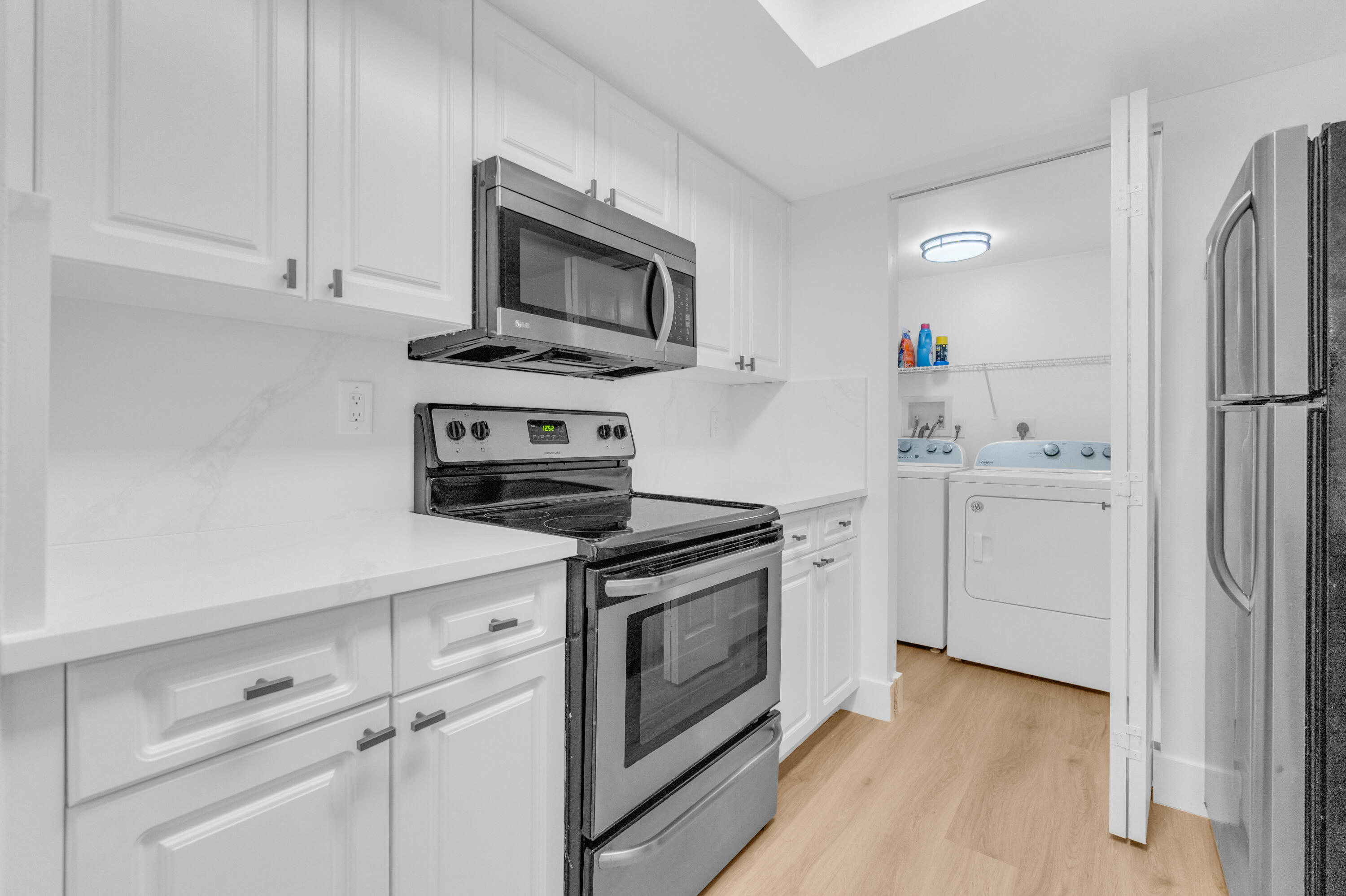400 Crestwood Court North, Unit 420 Royal Palm Beach, FL 33411 - Photo 31 of 44 a kitchen with white cabinets stainless steel appliances and sink