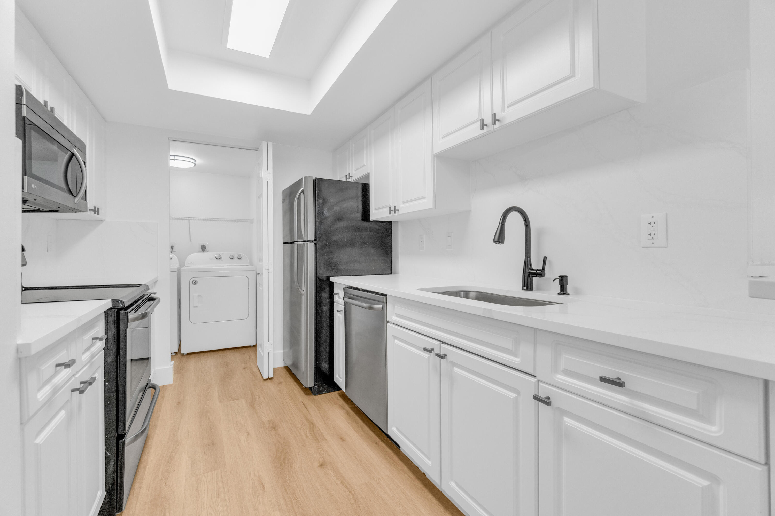 400 Crestwood Court North, Unit 420 Royal Palm Beach, FL 33411 - Photo 32 of 44 a kitchen with stainless steel appliances a refrigerator sink and cabinets