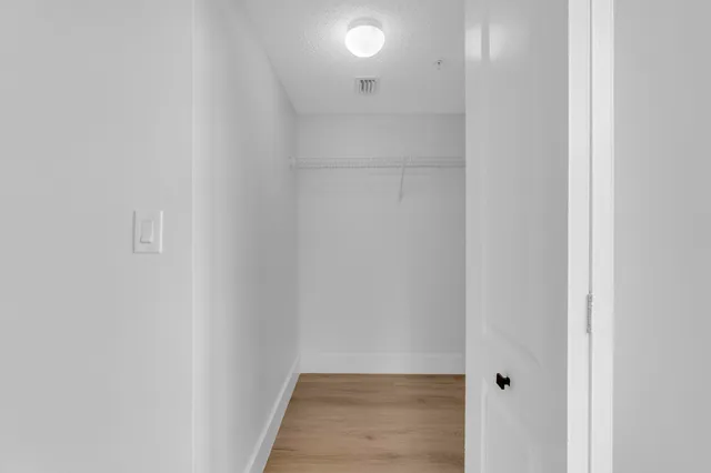 a view of a house with a backyard and tree