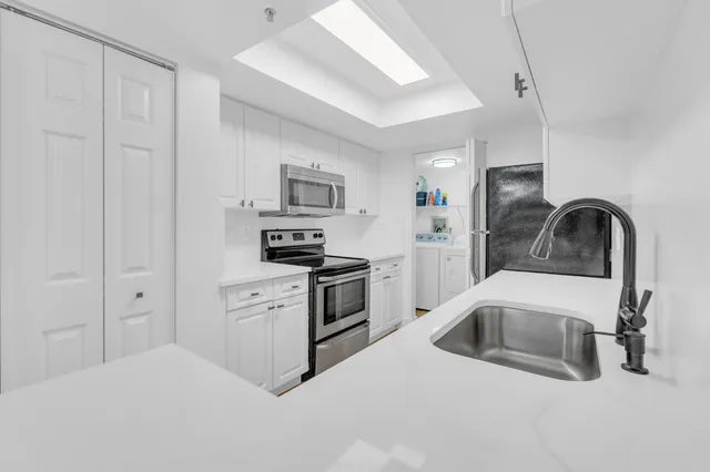 a kitchen with cabinets a sink and appliances