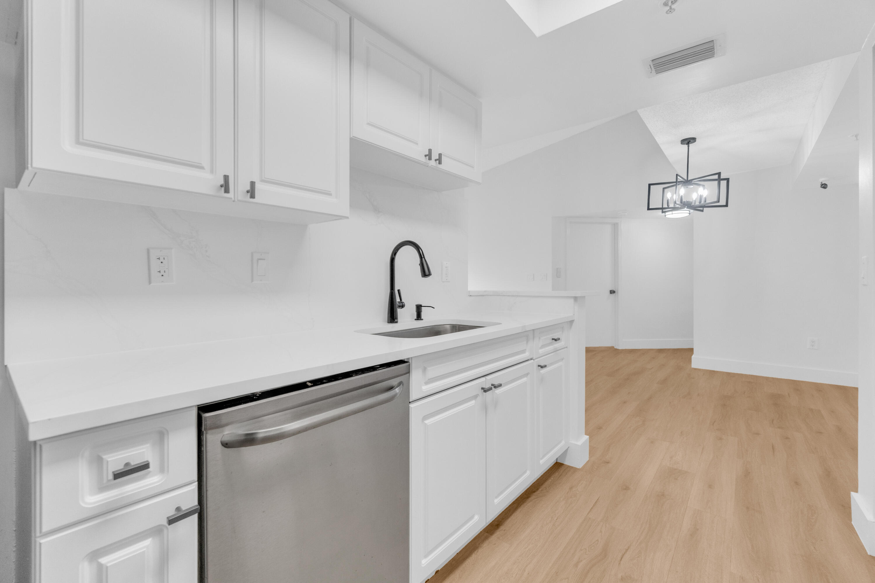 400 Crestwood Court North, Unit 420 Royal Palm Beach, FL 33411 - Photo 6 of 44 a kitchen with cabinets a sink and appliances