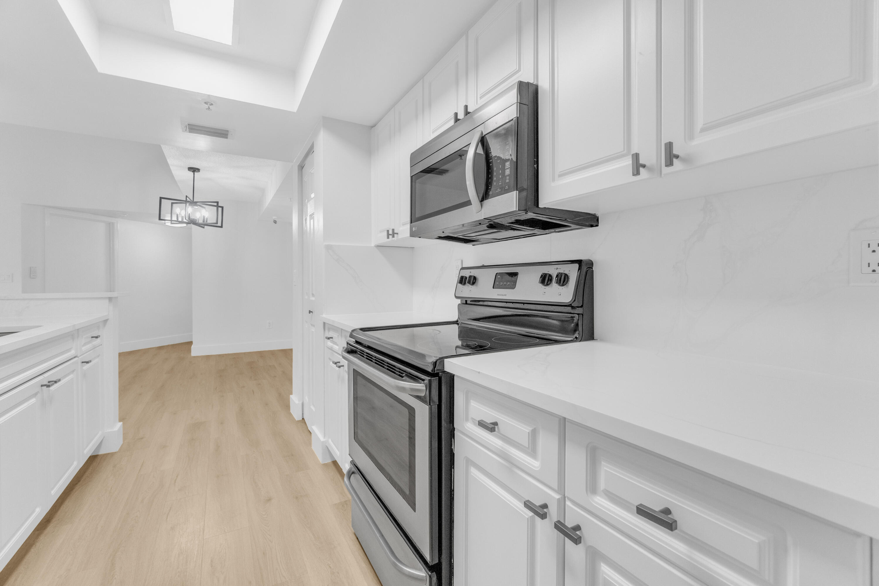 400 Crestwood Court North, Unit 420 Royal Palm Beach, FL 33411 - Photo 7 of 44 a kitchen with a stove and a microwave