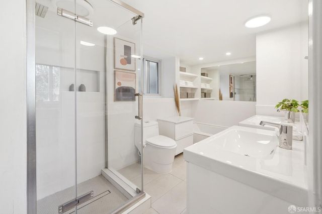 a bathroom with a sink toilet and shower