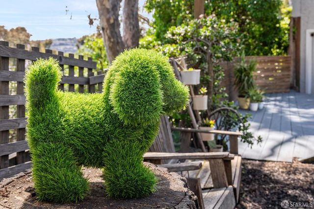 a view of a small house with wooden fence