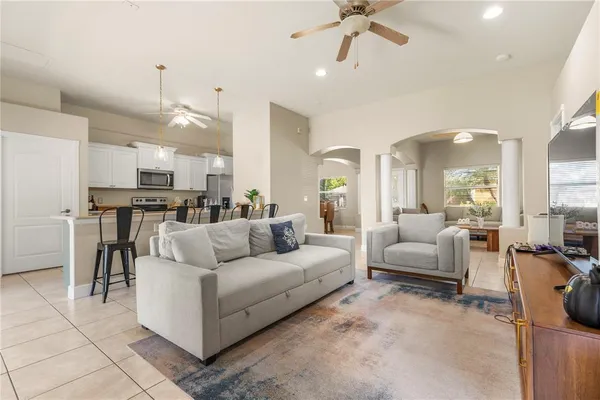 a living room with furniture and kitchen view