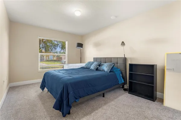 a bedroom with a bed and a window