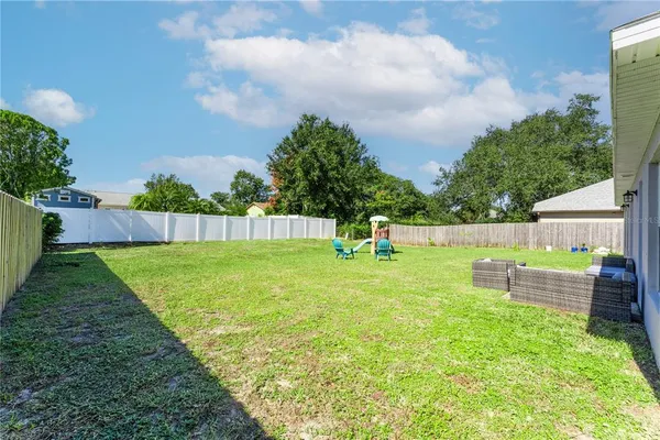 a view of a garden with a bench in the background