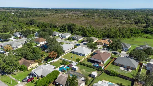 an aerial view of a houses with yard