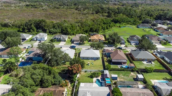 an aerial view of residential houses with outdoor space