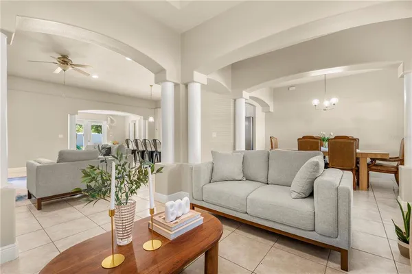 a living room with furniture and wooden floor