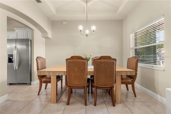 a view of a dining room with furniture and chandelier