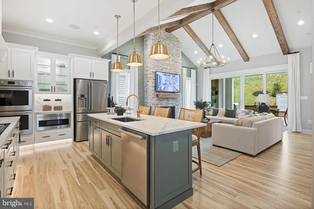 a dining room with furniture a chandelier and wooden floor