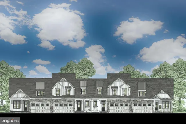 a view of entryway with wooden floor and windows