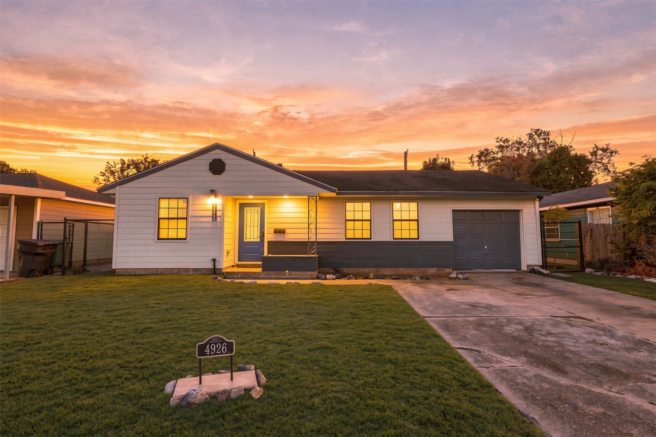4926 Edfield Street Houston, TX 77033 - Photo 1 of 30 Charming single-story home with a welcoming front porch and attached garage, set against a stunning sunset backdrop.