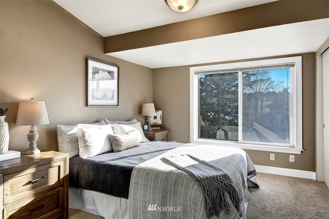 3224 21st Avenue West, Unit B Seattle, WA 98199 - Photo 12 of 17 a bedroom with a bed and a large window