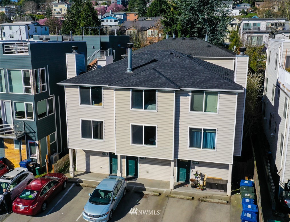 3224 21st Avenue West, Unit B Seattle, WA 98199 - Photo 17 of 17 a front view of a house with cars parked