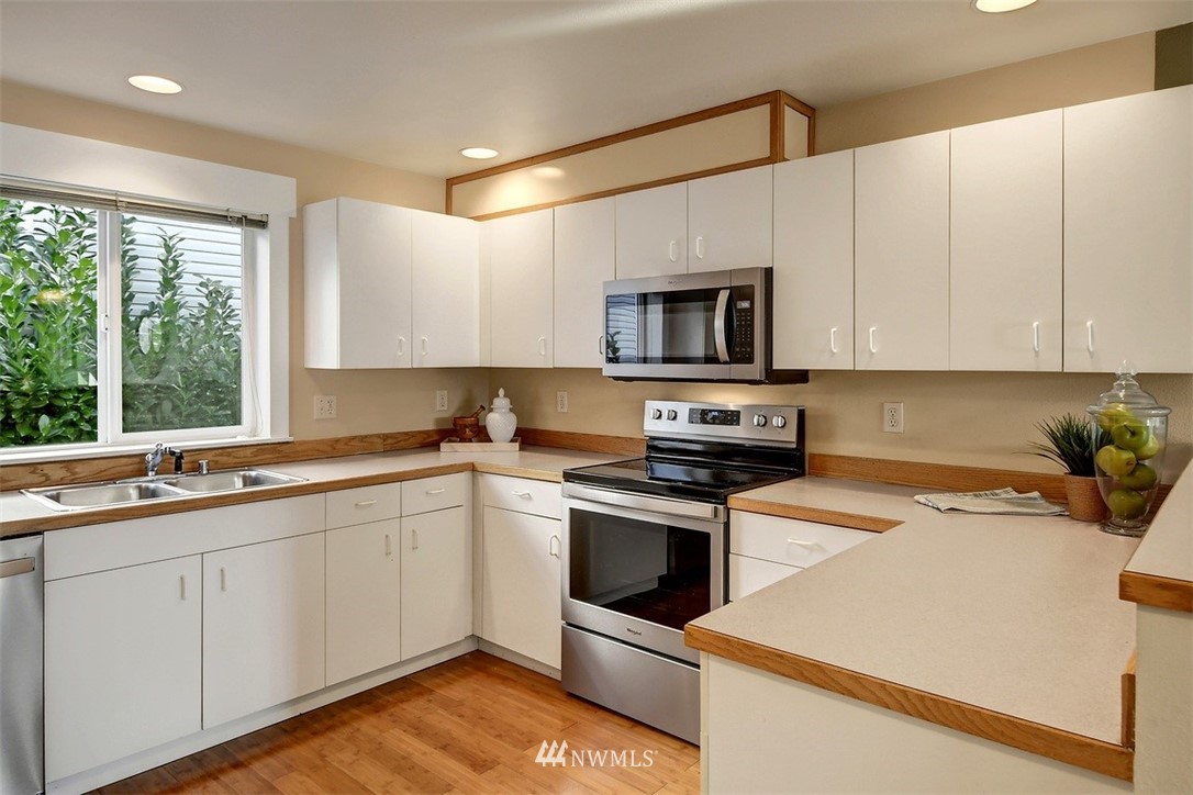 3224 21st Avenue West, Unit B Seattle, WA 98199 - Photo 3 of 17 a kitchen with a sink stove and microwave