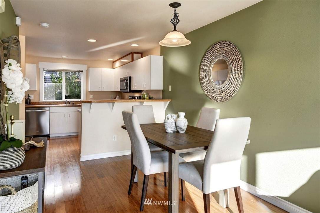 3224 21st Avenue West, Unit B Seattle, WA 98199 - Photo 5 of 17 a view of a dining room with furniture and wooden floor