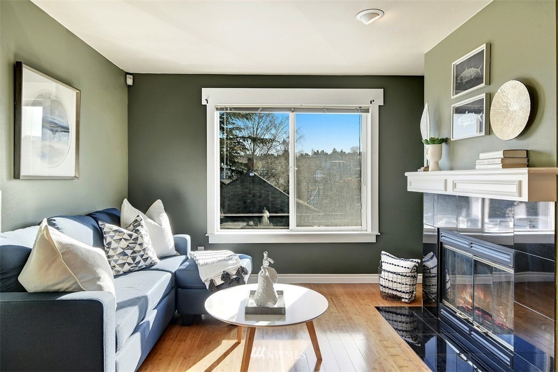 3224 21st Avenue West, Unit B Seattle, WA 98199 - Photo 6 of 17 a living room with furniture a window and a dining table