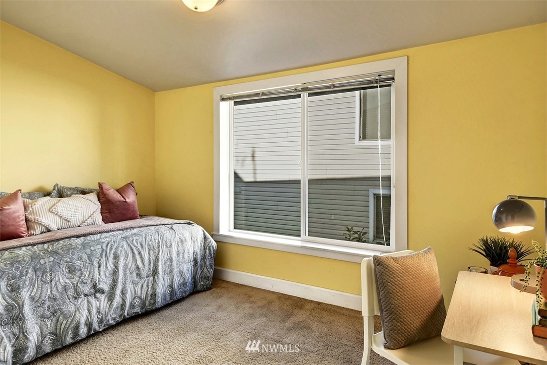 3224 21st Avenue West, Unit B Seattle, WA 98199 - Photo 9 of 17 a bedroom with a bed and wooden floor