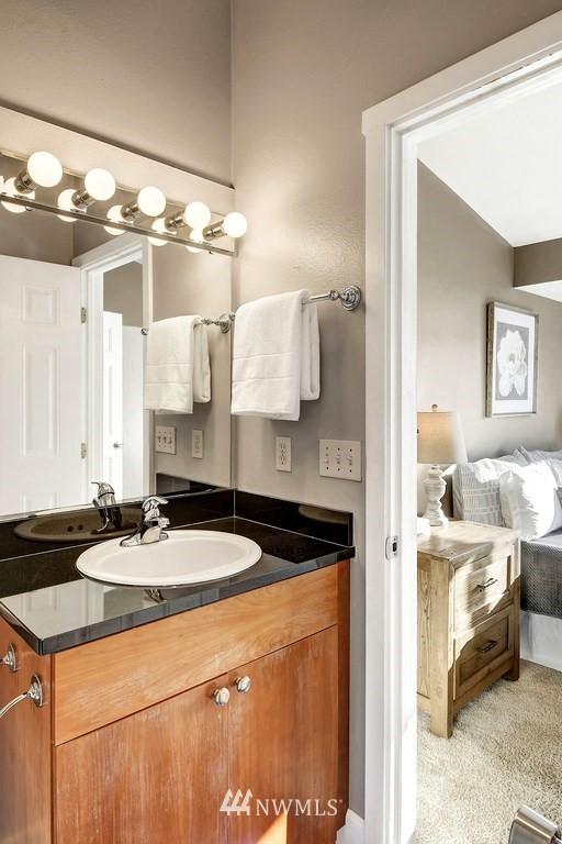 3224 21st Avenue West, Unit B Seattle, WA 98199 - Photo 10 of 17 a bathroom with a sink and a mirror