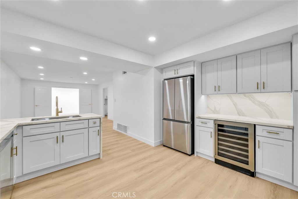 18 Meadowsweet Way Irvine, CA 92612 - Photo 10 of 66 a kitchen with a refrigerator and a sink