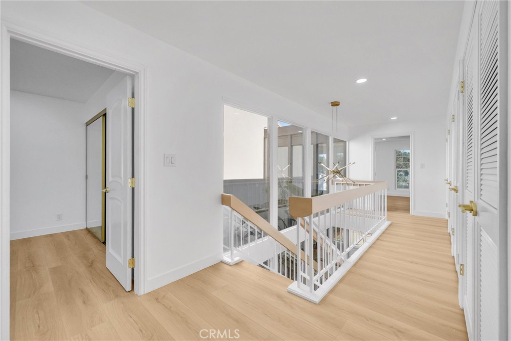 18 Meadowsweet Way Irvine, CA 92612 - Photo 26 of 66 a view of a hallway with wooden floor and a living room