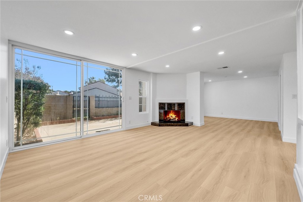 18 Meadowsweet Way Irvine, CA 92612 - Photo 3 of 66 a view of an empty room with wooden floor and a fireplace