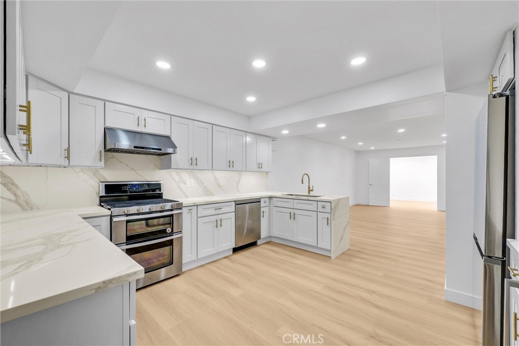 18 Meadowsweet Way Irvine, CA 92612 - Photo 9 of 66 a kitchen with a stove a sink and a refrigerator