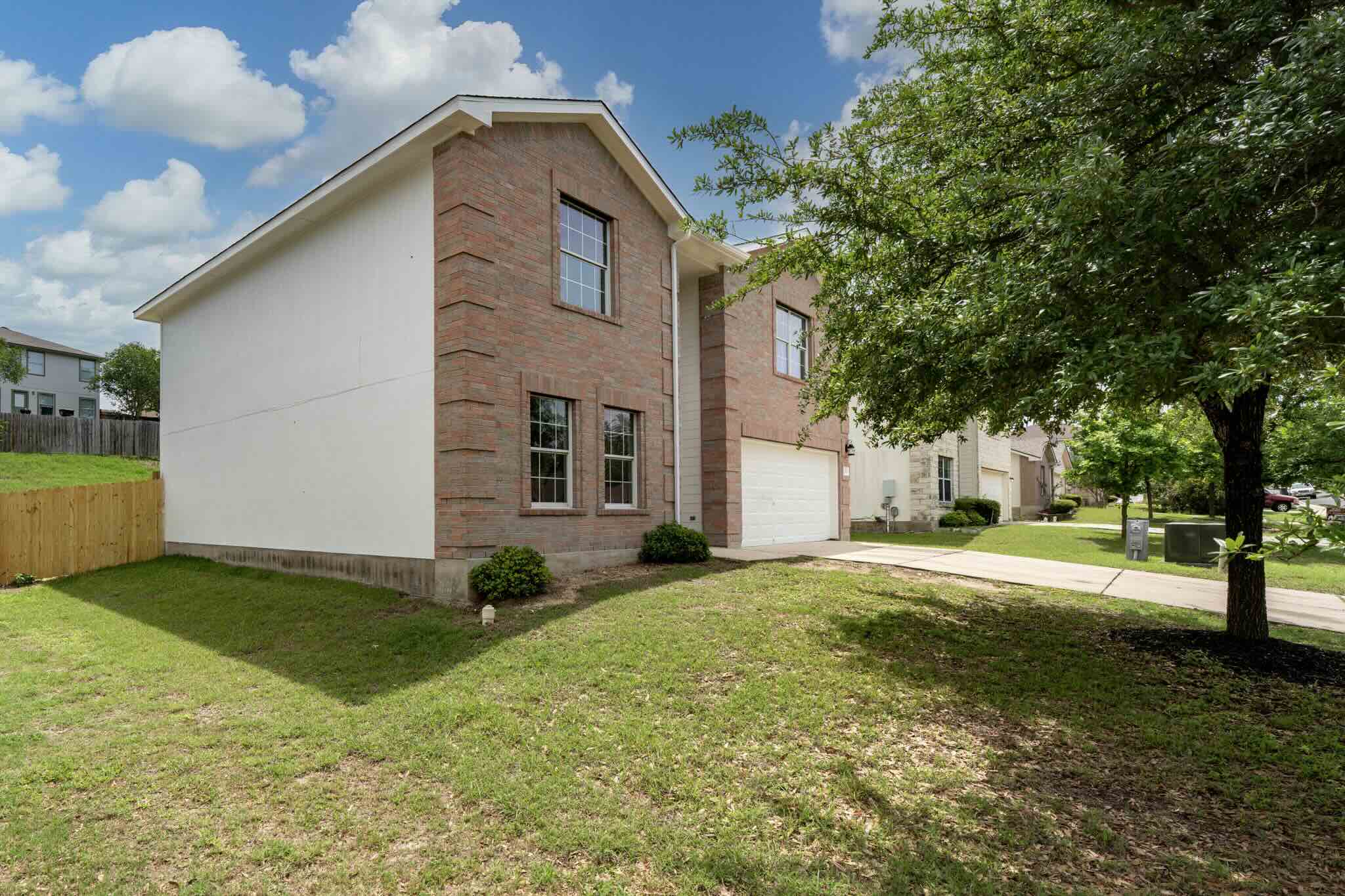 Two-story residence featuring brick and siding exterior construction