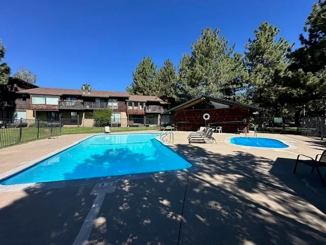 a swimming pool view with a seating space