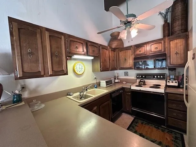 a kitchen with stainless steel appliances granite countertop a sink and a stove