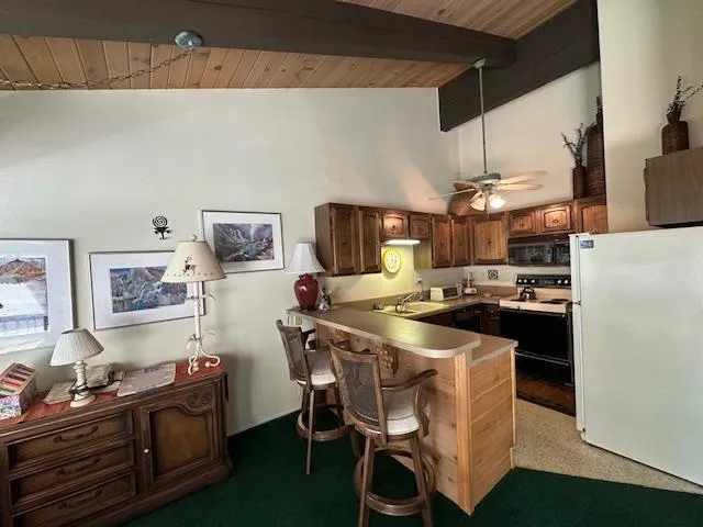 a kitchen with stainless steel appliances a stove a sink dishwasher and a refrigerator