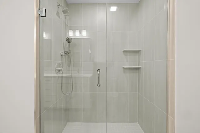 a bathroom with a glass shower door