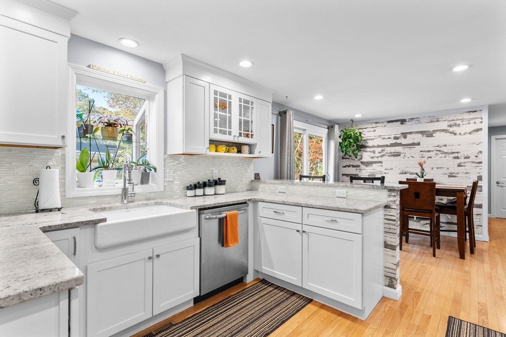 a kitchen with a sink window and cabinets
