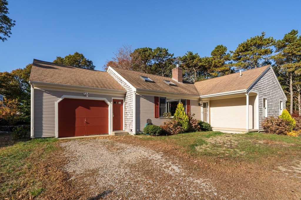 83 Dolar Davis Road Barnstable, MA 02632 - Photo 20 of 36 a front view of a house with a yard and garage