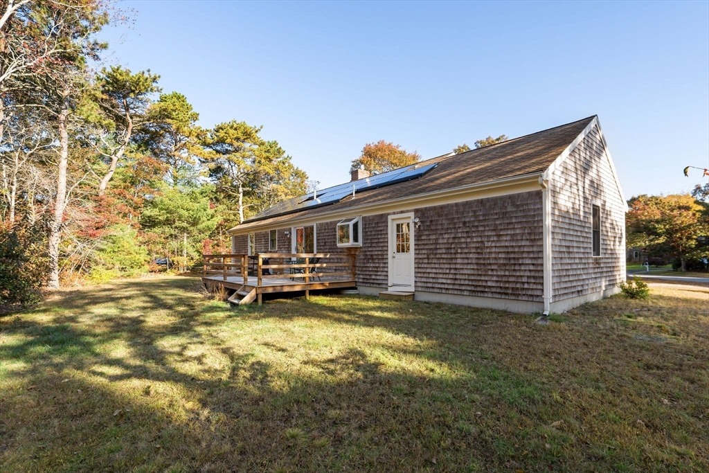 83 Dolar Davis Road Barnstable, MA 02632 - Photo 21 of 36 a view of a house with backyard porch and sitting area